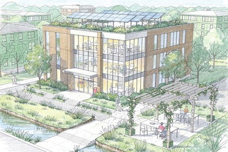 bâtiment entouré de verdure avec des panneaux solaires sur le toit comme exemple de prise en compte des enjeux bioclimatiques